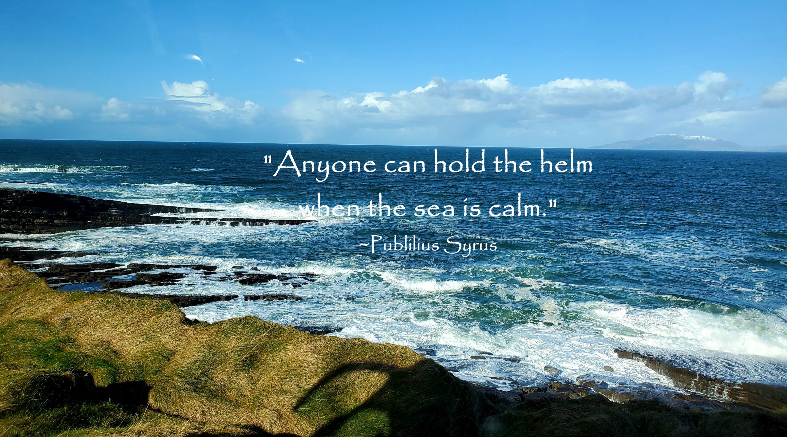 Irish sea with quote Anyone can hold the helm when the sea is calm by Publilius Syrus
